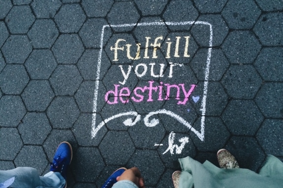 Artwork on pavement that reads 'fulfill your destiny'