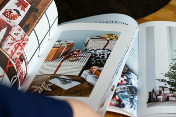 Open catalogues with pages displaying gift boxes